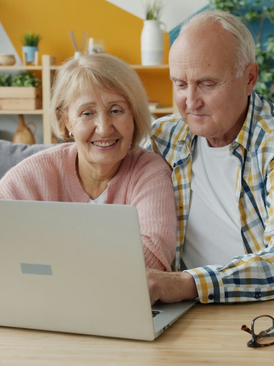 An older couple smiling together at home